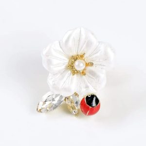 Mini brooch with a beetle on a flower